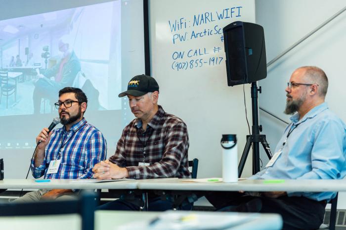 Figure 1. During a morning panel on Day 1 in Utqiaġvik, North Slope participants described the challenges they face from permafrost thaw and coastal erosion. From left, Griffin Hagle-Forster, Executive Director of TNHA, Yves Brower, Assistant Superintendent of BUECI, and Scott Evans, Director of the North Slope Borough Port Authority, discussed challenges related to permafrost foundation, utility infrastructure, and coastal erosion and sea walls, respectively. Photo courtesy of Lloyd Pikok/UIC Science.